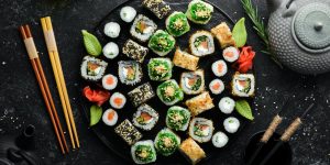 set-traditional-sushi-black-plate-sushi-rolls-dark-background-scaled