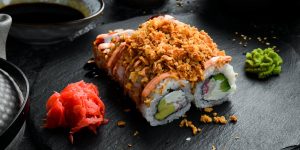 sushi-rolls-stone-plate-closeup-japanese-food-scaled